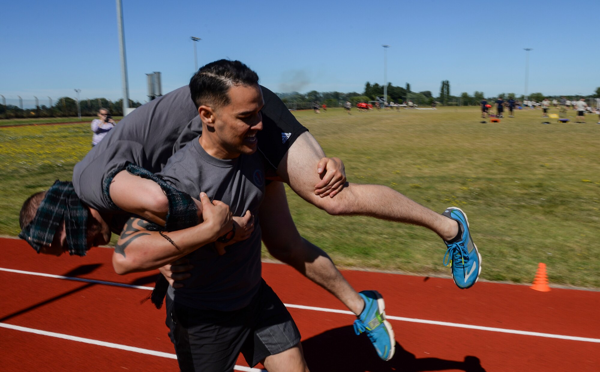 Air commandos from the 352d Special Operations Wing participate in a relay race during the Highland Games Sports and Family Day Aug. 26, 2016, on RAF Mildenhall, England. The relay consisted of a dummy carry, a zig-zag balance beam, tire flipping and a fireman’s carry. (U.S. Air Force photo by Staff Sgt. Micaiah Anthony)