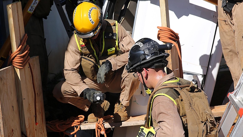 PERRY, Ga. - Marines with technical rescue and motor transport section, Chemical Biological Incident Response Force, CBIRF, prepare to reinforce a trench using plywood and gas struts in order to extract a simulated victim stuck inside a crashed vehicle, during Exercise Scarlet Response 2016 at Guardian Centers, Perry, Ga., Aug. 22, 2016. This exercise is the unit’s capstone event, testing the levels of each individual CBIRF capability with lane training and culminating with a 36-hour simulated response to a nuclear detonation. CBIRF is an active duty Marine Corps unit that, when directed, forward-deploys and/or responds with minimal warning to a chemical, biological, radiological, nuclear or high-yield explosive threat or event in order to assist local, state, or federal agencies and the geographic combatant commanders in the conduct of CBRNE response or consequence management operations, providing capabilities for command and control; agent detection and identification; search, rescue, and decontamination; and emergency medical care for contaminated personnel.