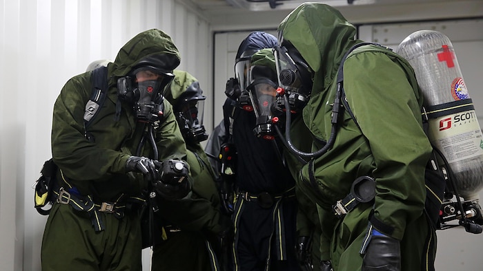 Sailors with Chemical Biological Incident Response Force, CBIRF, examine a contaminated chamber using a Multi-Rae monitor while donning their Class A personal protective equipment which includes self-contained breathing apparatus during Exercise Scarlet Response 2016 at Guardian Centers, Perry, Ga., Aug. 23, 2016. This exercise is the unit’s capstone event, testing the levels of each individual CBIRF capability with lane training and culminating with a 36-hour simulated response to a nuclear detonation. CBIRF is an active duty Marine Corps unit that, when directed, forward-deploys and/or responds with minimal warning to a chemical, biological, radiological, nuclear or high-yield explosive threat or event in order to assist local, state, or federal agencies and the geographic combatant commanders in the conduct of CBRNE response or consequence management operations, providing capabilities for command and control; agent detection and identification; search, rescue, and decontamination; and emergency medical care for contaminated personnel.