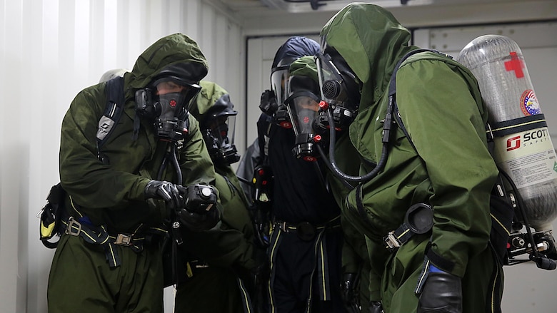 Sailors with Chemical Biological Incident Response Force, CBIRF, examine a contaminated chamber using a Multi-Rae monitor while donning their Class A personal protective equipment which includes self-contained breathing apparatus during Exercise Scarlet Response 2016 at Guardian Centers, Perry, Ga., Aug. 23, 2016. This exercise is the unit’s capstone event, testing the levels of each individual CBIRF capability with lane training and culminating with a 36-hour simulated response to a nuclear detonation. CBIRF is an active duty Marine Corps unit that, when directed, forward-deploys and/or responds with minimal warning to a chemical, biological, radiological, nuclear or high-yield explosive threat or event in order to assist local, state, or federal agencies and the geographic combatant commanders in the conduct of CBRNE response or consequence management operations, providing capabilities for command and control; agent detection and identification; search, rescue, and decontamination; and emergency medical care for contaminated personnel.