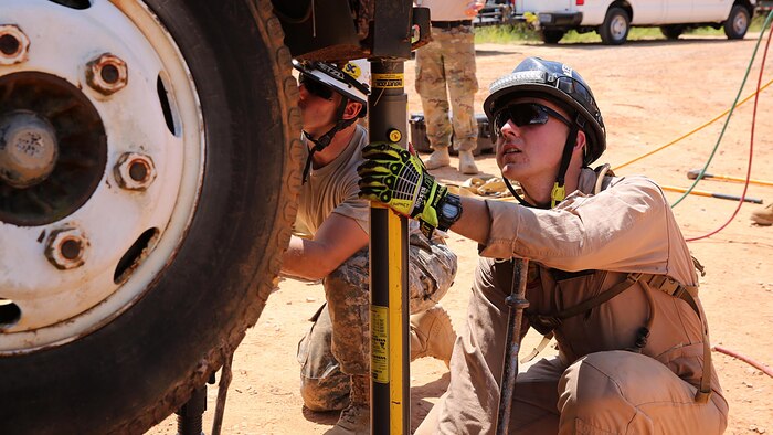 Marines with technical rescue platoon, Chemical Biological Incident Response Force, CBIRF, use paratech struts to stabilize a truck and extricate a simulated victim during training with soldiers from 911th Technical Rescue Engineer Company stationed at Fort Belvoir, Va., as part of Exercise Scarlet Response 2016 at Guardian Centers, Perry, Ga., Aug. 23, 2016. This exercise is the unit’s capstone event, testing the levels of each individual CBIRF capability with lane training and culminating with a 36-hour simulated response to a nuclear detonation. CBIRF is an active duty Marine Corps unit that, when directed, forward-deploys and/or responds with minimal warning to a chemical, biological, radiological, nuclear or high-yield explosive threat or event in order to assist local, state, or federal agencies and the geographic combatant commanders in the conduct of CBRNE response or consequence management operations, providing capabilities for command and control; agent detection and identification; search, rescue, and decontamination; and emergency medical care for contaminated personnel.