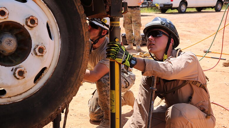 Marines with technical rescue platoon, Chemical Biological Incident Response Force, CBIRF, use paratech struts to stabilize a truck and extricate a simulated victim during training with soldiers from 911th Technical Rescue Engineer Company stationed at Fort Belvoir, Va., as part of Exercise Scarlet Response 2016 at Guardian Centers, Perry, Ga., Aug. 23, 2016. This exercise is the unit’s capstone event, testing the levels of each individual CBIRF capability with lane training and culminating with a 36-hour simulated response to a nuclear detonation. CBIRF is an active duty Marine Corps unit that, when directed, forward-deploys and/or responds with minimal warning to a chemical, biological, radiological, nuclear or high-yield explosive threat or event in order to assist local, state, or federal agencies and the geographic combatant commanders in the conduct of CBRNE response or consequence management operations, providing capabilities for command and control; agent detection and identification; search, rescue, and decontamination; and emergency medical care for contaminated personnel.