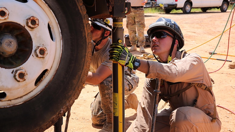 Marines with technical rescue platoon, Chemical Biological Incident Response Force, CBIRF, use paratech struts to stabilize a truck and extricate a simulated victim during training with soldiers from 911th Technical Rescue Engineer Company stationed at Fort Belvoir, Va., as part of Exercise Scarlet Response 2016 at Guardian Centers, Perry, Ga., Aug. 23, 2016. This exercise is the unit’s capstone event, testing the levels of each individual CBIRF capability with lane training and culminating with a 36-hour simulated response to a nuclear detonation. CBIRF is an active duty Marine Corps unit that, when directed, forward-deploys and/or responds with minimal warning to a chemical, biological, radiological, nuclear or high-yield explosive threat or event in order to assist local, state, or federal agencies and the geographic combatant commanders in the conduct of CBRNE response or consequence management operations, providing capabilities for command and control; agent detection and identification; search, rescue, and decontamination; and emergency medical care for contaminated personnel.