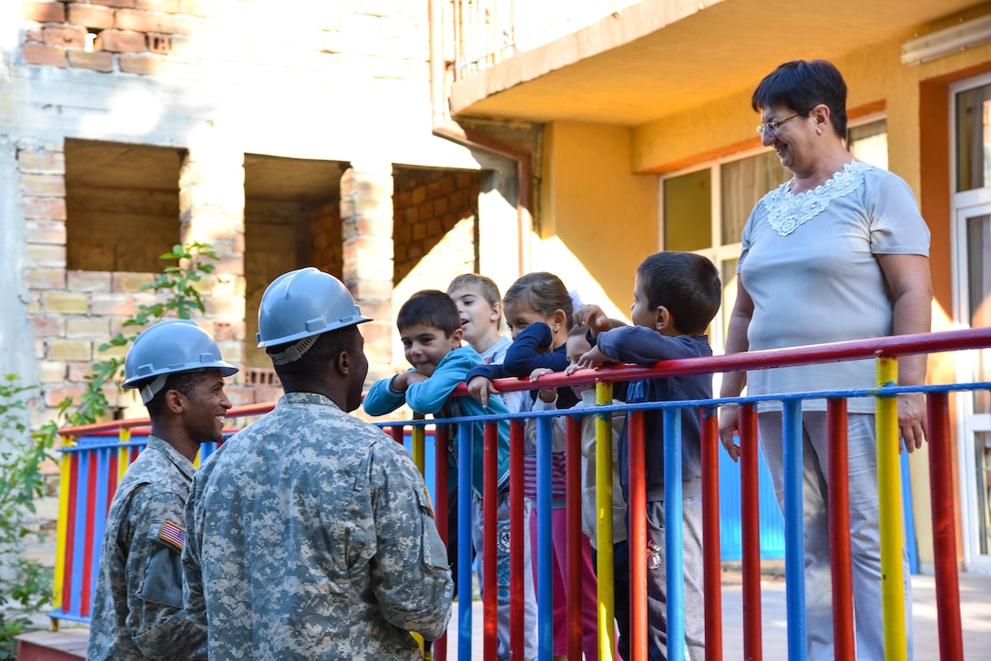 U.S. Soldiers with the 375th Engineer Company, Huntsville, Alabama, talk with kindergarten children and teacher during a Humanitarian Civil Assistance project, Kalifarevo, Bulgaria, Aug. 26, 2016. As a part of the European Command’s (EUCOM) Humanitarian a Civic Assistance Program, the U.S. Army reserve 457th Civil Affairs Battalion, the 375th Engineer Company, U.S. Air Force National Guard 164th Civil Engineer Squadron and the Bulgarian Army collaborate to renovate a kindergarten. (U.S. Army photo by Spc. Nathanael Mercado)