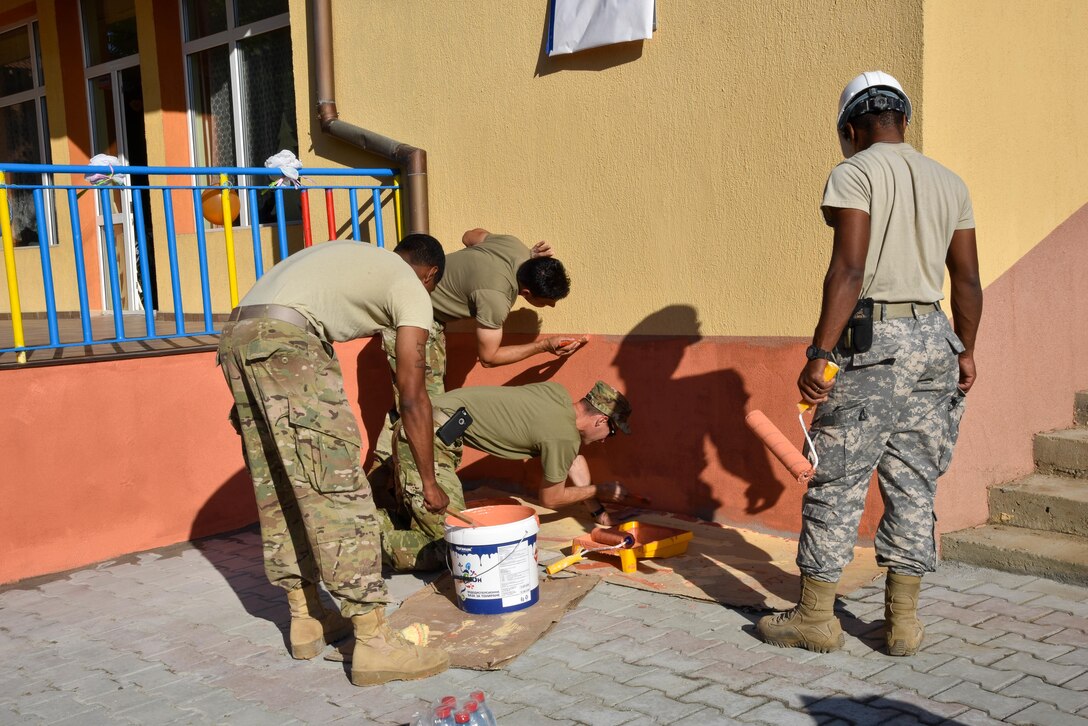 U.S. Soldiers with the 457th Civil Affairs Battalion and 375th Engineer Company repaint the exterior walls during a Humanitarian Civil Assistance project in Kalifarevo, Bulgaria, Aug. 26, 2016. As a part of the European Command’s (EUCOM) Humanitarian a Civic Assistance Program, the U.S. Army reserve 457th Civil Affairs Battalion, the 375th Engineer Company, U.S. Air Force National Guard 164th Civil Engineer Squadron and the Bulgarian Army collaborate to renovate a Kindergarten. The Humanitarian and Civic Assistance Program is a series of medical and engineering engagements in several European countries in support of strategic, theater, operational and tactical objectives.(U.S. Army photo by Spc. Nathanael Mercado)