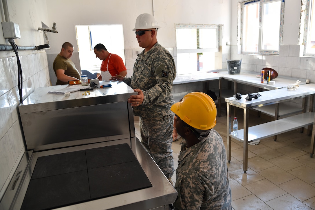 U.S. Soldiers with the 375th Engineer Company and Bulgarian soldiers install kitchen appliances during a Humanitarian Civil Assistance project, Kalifarevo, Bulgaria, Aug. 26, 2016. As a part of the European Command’s (EUCOM) Humanitarian a Civic Assistance Program, the U.S. Army reserve 457th Civil Affairs Battalion, the 375th Engineer Company, U.S. Air Force National Guard 164th Civil Engineer Squadron and the Bulgarian Army collaborate to renovate a Kindergarten. The Humanitarian and Civic Assistance Program is a series of medical and engineering engagements in several European countries in support of strategic, theater, operational and tactical objectives. (U.S. Army photo by Spc. Nathanael Mercado)