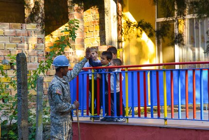 U.S. Soldier with the 375th Engineer Company, Huntsville, Alabama, gives a high-five to a children during a Humanitarian Civil Assistance project, Kalifarevo, Bulgaria, Aug. 26, 2016. As a part of the European Command’s (EUCOM) Humanitarian a Civic Assistance Program, the U.S. Army reserve 457th Civil Affairs Battalion, the 375th Engineer Company, U.S. Air Force National Guard 164th Civil Engineer Squadron and the Bulgarian Army collaborate to renovate. (U.S. Army photo by Spc. Nathanael Mercado)