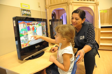 Treasea Landreth (right), child youth program assistant, helps Elizabeth Hernandez navigate through a computer program Aug. 17, 2016 at the Joint Base San Antonio-Randolph Child Development Center. Following a lengthy construction and renovation project which doubled the space of its two facilities, the CDP will accommodate 282 children – 192 at its main building on New B Street West and 90 at its annex on H Street.

