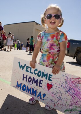 A child awaits her mother’s return at Dock 9 at Minot Air Force Base, N.D., Aug. 29, 2016. The 69th Bomb Squadron returned home after a six-month deployment to Andersen Air Force Base, Guam. (U.S. Air Force photo/Airman 1st Class J.T. Armstrong)
