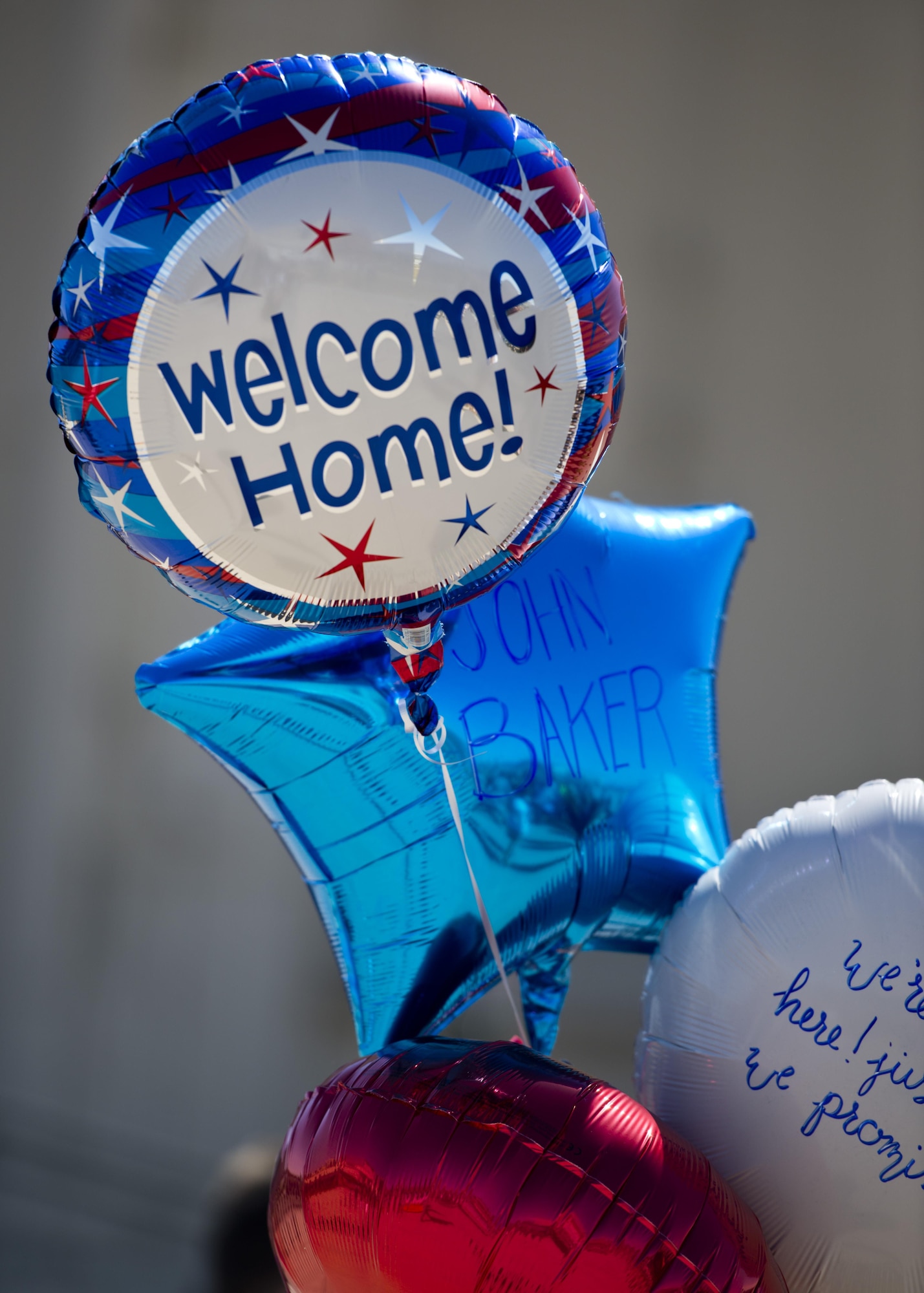 Balloons are held by family members of a deployed Airman at Minot Air Force Base, N.D., Aug. 29, 2016. Family members awaited the 69th Bomb Squadron’s return home after a six-month deployment to Andersen Air Force Base, Guam. (U.S. Air Force photo/Airman 1st Class J.T. Armstrong)