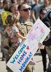 Capt. John Nep, 54th Helicopter Squadron UH-1N evaluator pilot, awaits his wife’s return at Minot Air Force Base, N.D., Aug. 29, 2016.  Nep and his daughter waited with other Team Minot families to greet Airmen returning from Andersen Air Force Base, Guam. (U.S. Air Force photo/Airman 1st Class J.T. Armstrong)
