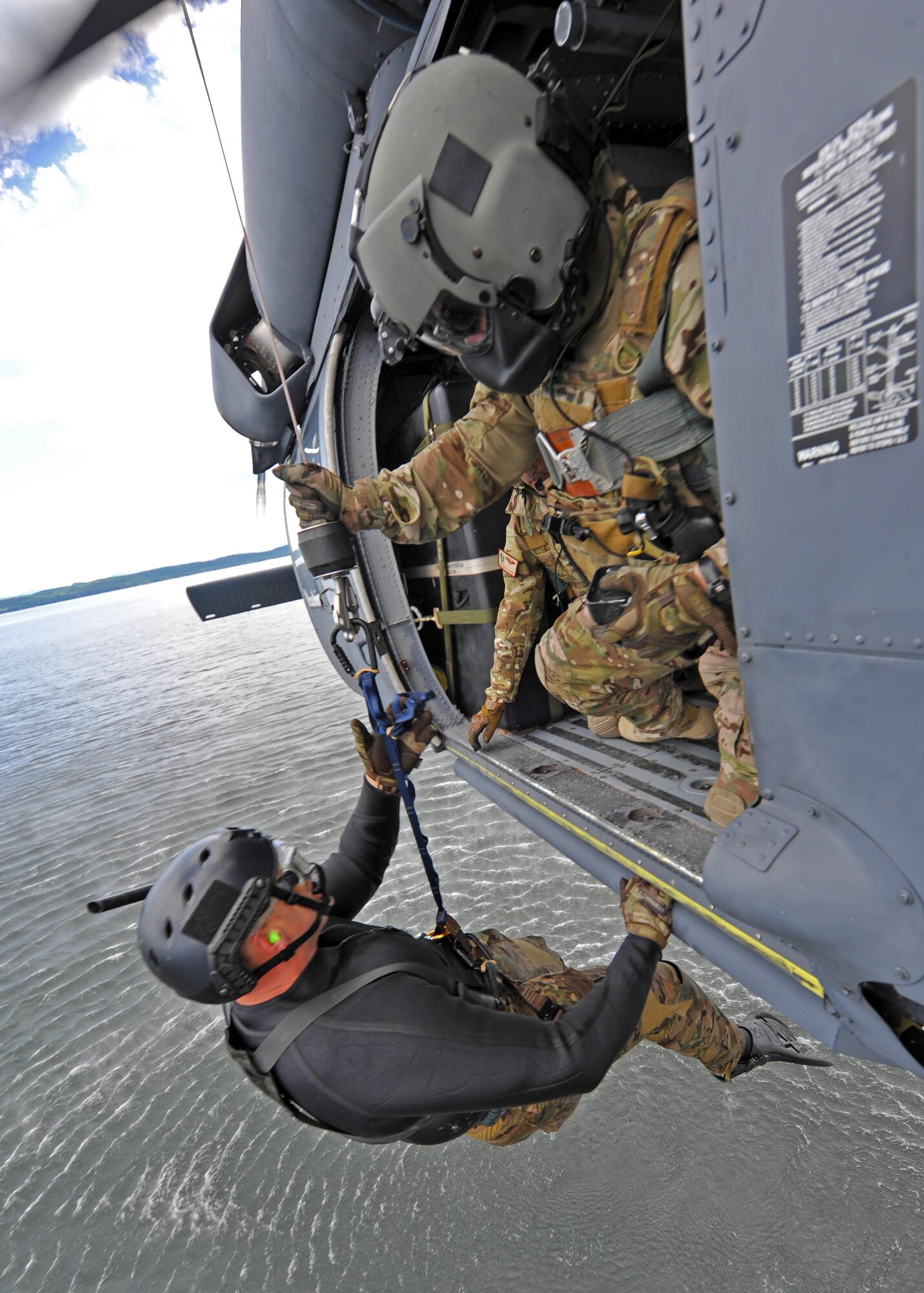 Tech. Sgt. Gary Waltz, an Air Force Reserve SERE (Survive, Evade, Resist, Escape) specialist, is hoisted from the waters of Lake Champlain, NY, during training Aug. 7. SERE specialists are part of the Guardian Angel weapons system of Air Combat Command along with pararescuemen and combat rescue officers. Waltz is assigned to the 306th Rescue Squadron, 943rd Rescue Group, Davis-Monthan Air Force Base, Ariz. (U.S. Air Force photo by Carolyn Herrick)
