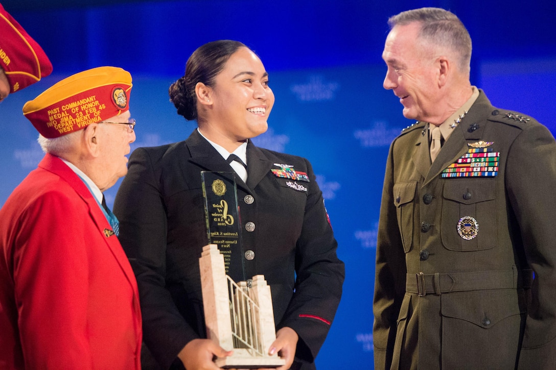 Marine Corps Gen. Joe Dunford, right, chairman of the Joint Chiefs of Staff, and Medal of Honor recipient Hershel “Woody” Williams, left, present an American Legion Spirit of Service Award to Navy Petty Officer 2nd Class Levetina S. King during the Legion's 98th national convention in Cincinnati, Aug. 30, 2016. Dunford also delivered remarks at the convention. DoD photo by Navy Petty Officer 2nd Class Dominique A. Pineiro