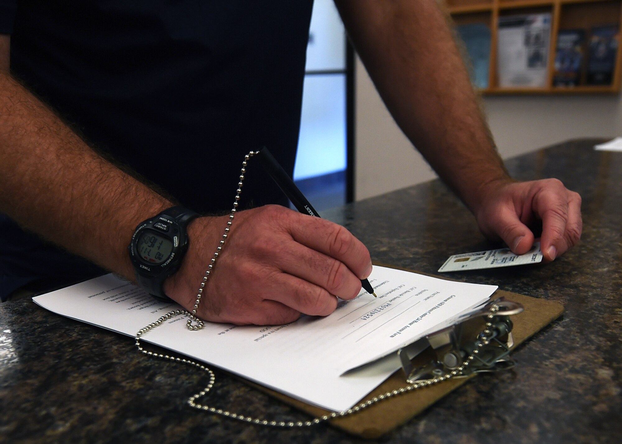 A member with a common access card fills out a form that allows them to use Grissom’s 24 hour fitness center at Grissom Air Reserve Base, Ind., July 11, 2016. Members are required to sign an acknowledgement of the fitness center guidelines following which they will be shown the location of emergency equipment including the newly installed automated external defibrillator (AED) and emergency phone.(U.S. Air Force photo/Senior Airman Andrew Crawford)