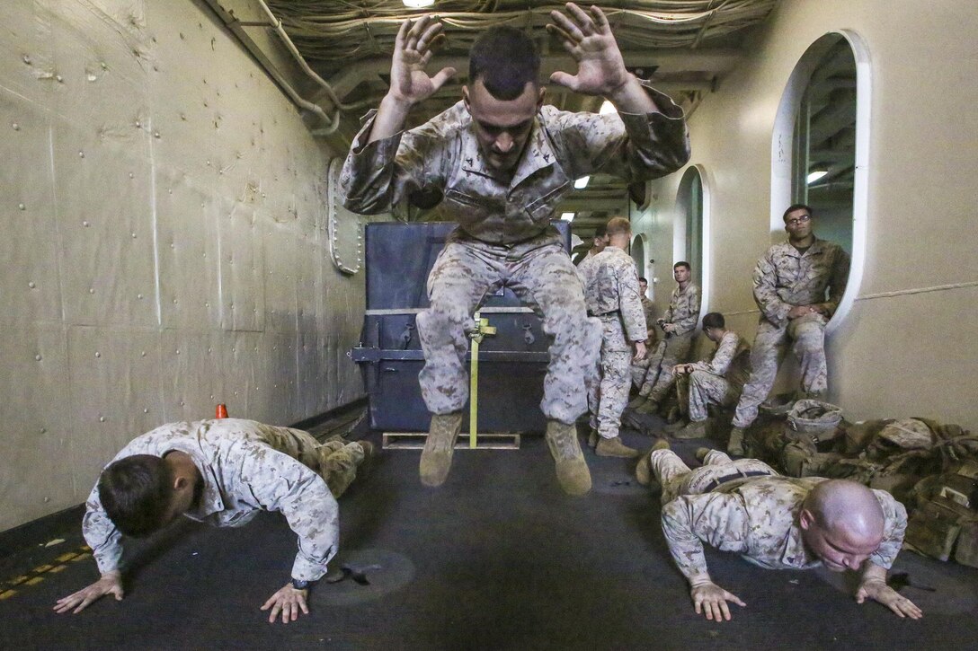 Marines do burpees, which work the entire body, during a physical fitness and weapons knowledge test on the USS San Antonio in the Gulf of Aden, Aug. 30, 2016. The Marines, assigned to the 22nd Marine Expeditionary Unit, are maintaining regional security in the U.S. 5th Fleet area of operations. Marine Corps photo by Sgt. Ryan Young