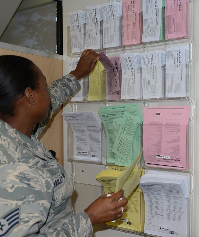 U.S. Air Force Staff Sgt. Adele Dailey-Thomas, 633rd Medical Operations Squadron Allergy and Immunizations Clinic noncommissioned officer-in-charge, provides vaccine information to parents at the pediatric immunizations clinic at Langley Air Force Base, Va., Aug. 31, 2016. The clinic provides information on a variety of vaccines, both those that are required and recommended by the Commonwealth of Virginia and the Center for Disease Control. (U.S. Air Force photo by Staff Sgt. Teresa J. Cleveland)