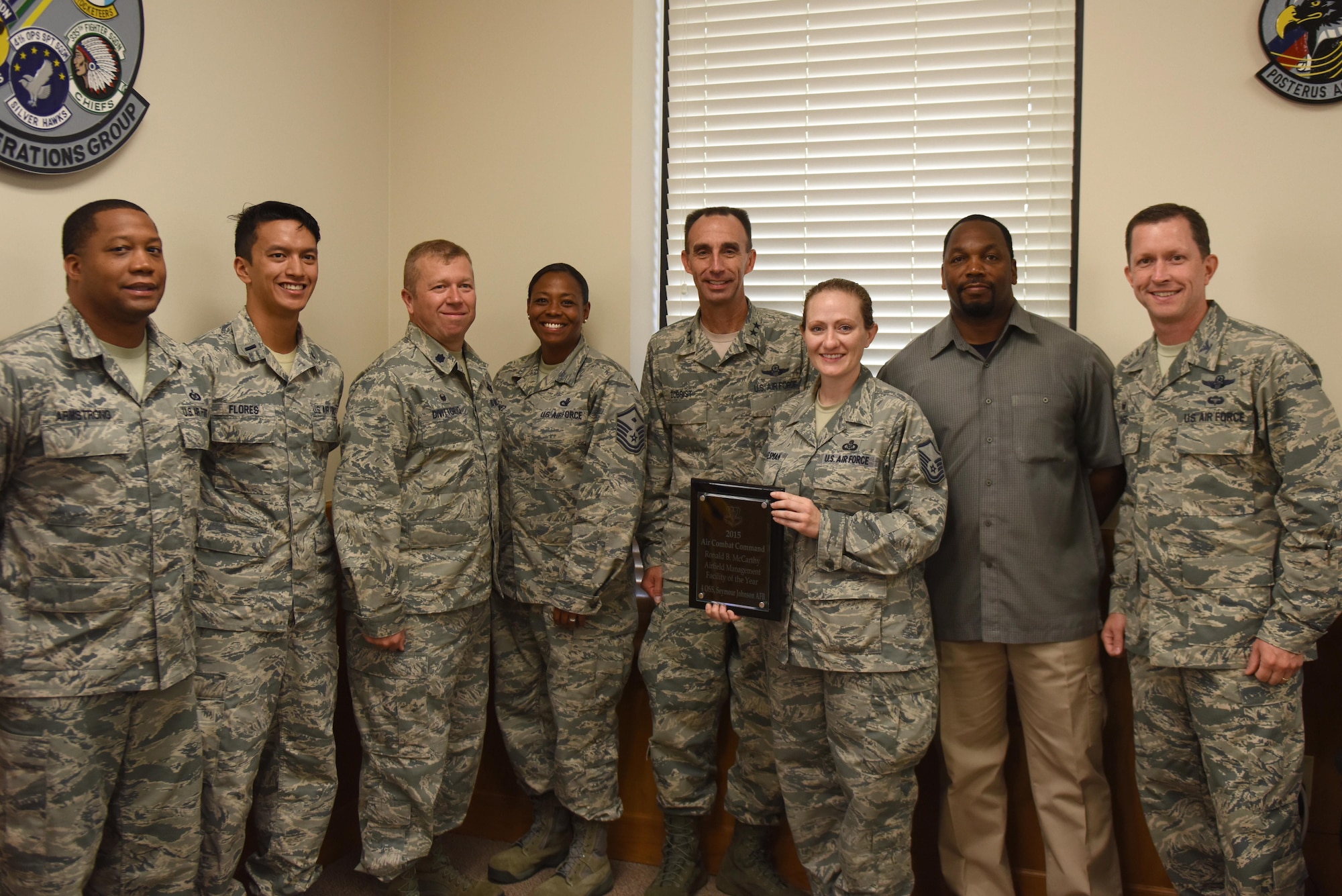 Maj. Gen. Scott Zobrist (center), 9th Air Force commander, presents Master Sgt. Devon Foresman (center right), 4th Operations Support Squadron airfield manager, after presenting the Air Combat Command Ronald B. McCarthy Airfield Management Facility of the Year Award, Aug. 23, 2016, at Seymour Johnson Air Force Base, North Carolina. An airfield management unit has to have made a notable contribution to the operations of an airfield, such as superior coordination efforts during airfield construction and maintenance activities, to qualify for this award. (U.S. Air Force photo by Airman 1st Class Ashley Williamson)