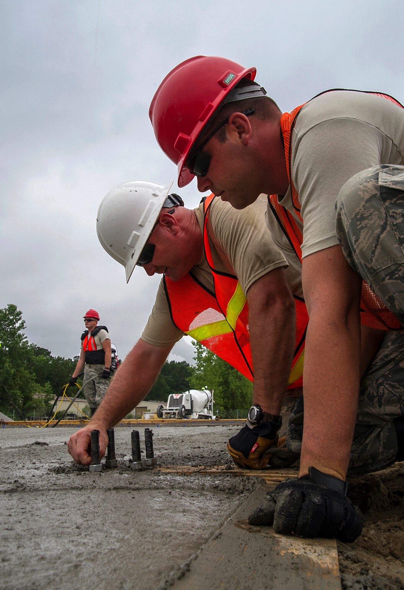 (White hat) Master Sgt. Thomas Martin, 556th RED HORSE Squadron from Hurlbut Field, Florida,  and (Red hat) Brett Bowen, 560th RHS from Joint Base Charleston attach nuts to framing anchor bolts during a construction project at Joint Base Charleston.  Members of the 560th RHS, 628th Civil Engineer Squadron at Joint Base Charleston, 556th RHS, 555th RHS from Nellis Air Force Base, Nevada, and 567th RHS from Seymour Johnson Air Force Base, North Carolina joined forces June, July and August at Joint Base Charleston to build a 4,800 square-foot preengineered  building building to store 560th RHS construction equipment and gear.  Rapid Engineer Deployable, Heavy Operational Repair Squadron, Engineer (RED HORSE) squadrons provide the Air Force with a highly mobile civil engineering capability in support of contingency and special operations worldwide. They are self-sufficient, mobile squadrons that provide heavy construction support such as runway/facility construction, electrical upgrades, and equipment transport when requirements exceed normal base civil engineer capabilities and where Army engineer support is not readily available. (U.S. Air Force Photo by Michael Dukes)