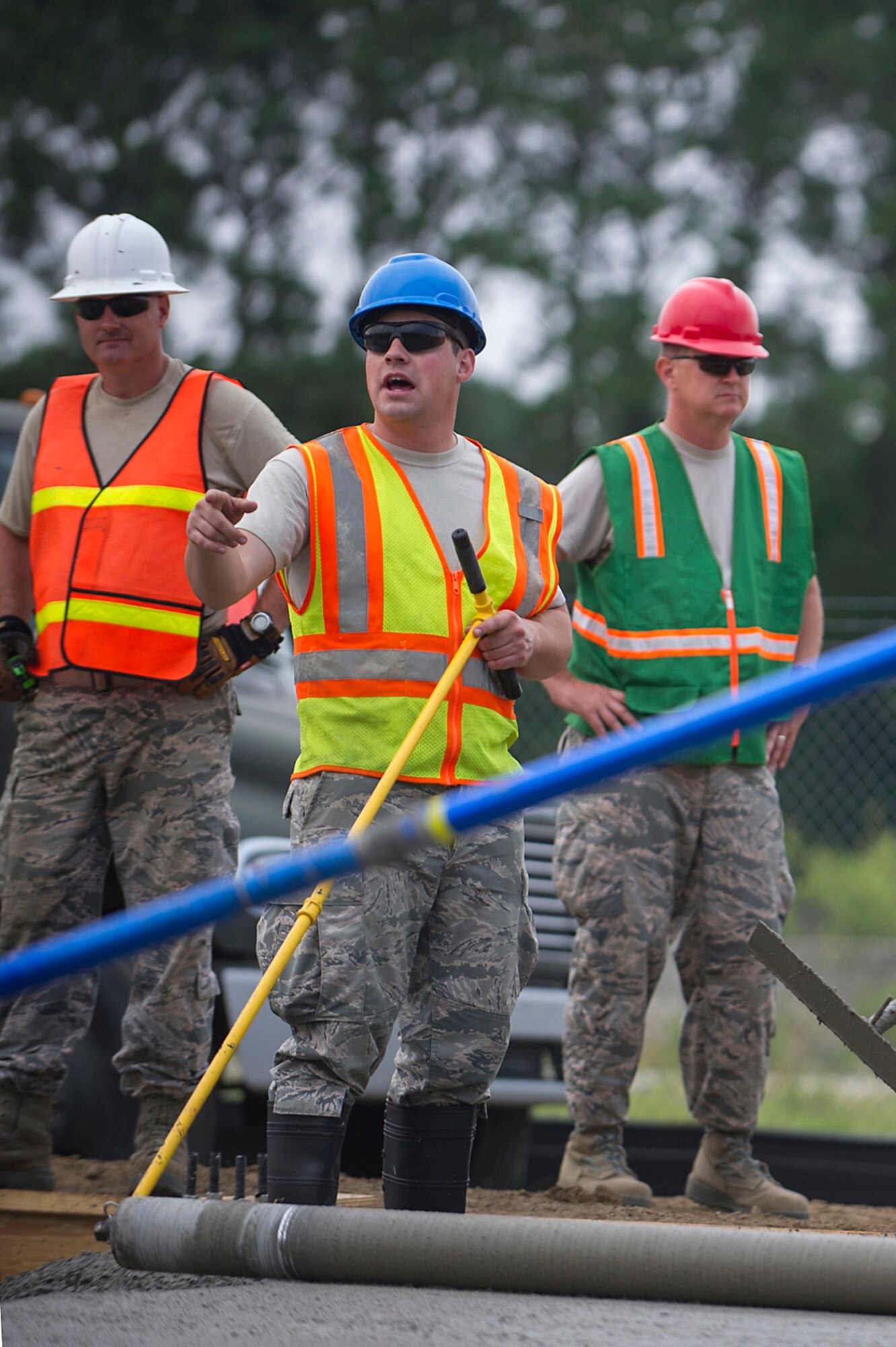 (From left) Master Sgt. Thomas Martin, 556th RED HORSE Squadron at Hurlburt Field, Florida, Senior Airman Jesse Steinberg, 628th Civil Engineer Squadron at Joint Base Charleston, and Tech Sgt. Bradley Atherton, 560th RHS at Joint Base Charleston, spread concrete with a roller screed during a joint construction project at Joint Base Charleston. Members of the 560th RHS, 628th CES, 556th RHS, 555th RHS from Nellis Air Force Base, Nevada, and 567th RHS from Seymour Johnson Air Force Base, North Carolina joined forces June, July and August at Joint Base Charleston to build a 4,800 square-foot preengineered  building building to store 560th RHS construction equipment and gear.  Rapid Engineer Deployable, Heavy Operational Repair Squadron, Engineer (RED HORSE) squadrons provide the Air Force with a highly mobile civil engineering capability in support of contingency and special operations worldwide. They are self-sufficient, mobile squadrons that provide heavy construction support such as runway/facility construction, electrical upgrades, and equipment transport when requirements exceed normal base civil engineer capabilities and where Army engineer support is not readily available. (U.S. Air Force Photo by Michael Dukes)