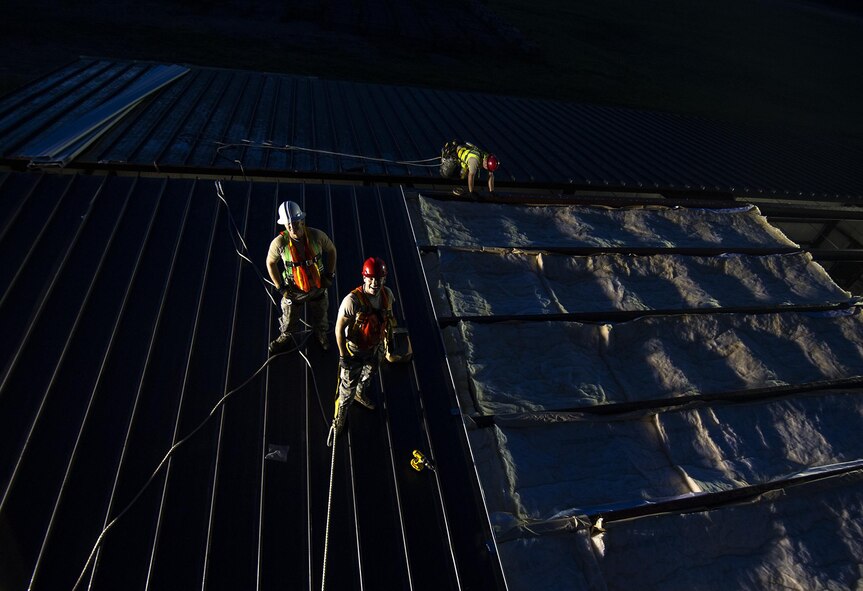 Master Sgt. Thomas Martin, 556th RED HORSE Squadron, Master Sgt. Blaine Graves 556th RHS and Tech Sgt. Dmitriy Kobzar 560th RHS lay roof panels on a new storage building July 17 at Joint Base Charleston, S.C. Members of the 556th RHS from Hurlburt Field, Florida, 555th RHS from Nellis Air Force Base, Nevada, 567th RHS from Seymour Johnson AFB, North Carolina, and the 628th Civil Engineer Squadron at Joint Base Charleston, joined the 560th RHS over a 6 month period to construct a 4,800 square-foot steel frame storage facility. (U.S. Air Force photo by Michael Dukes)
