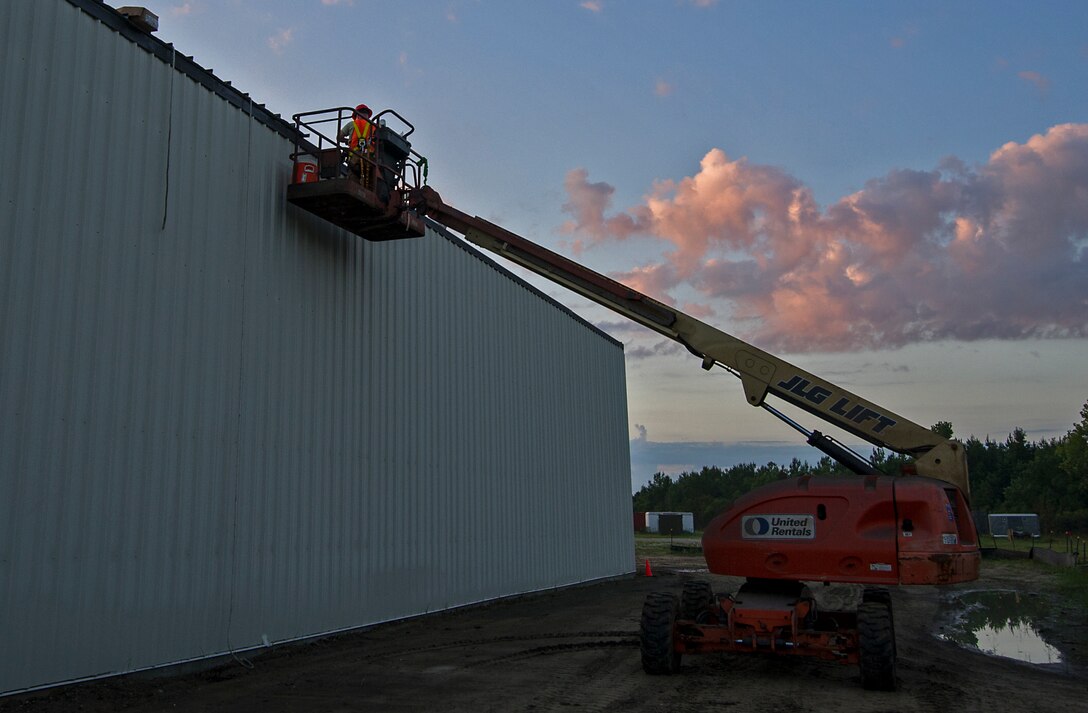 RED HORSE Reservists work on the roof of a new storage building July 19 that they are constructing at Join Base Charleston, S.C.  Members of the 556th RHS from Hurlburt Field, Florida, 555th RHS from Nellis Air Force Base, Nevada, 567th RHS from Seymour Johnson AFB, North Carolina, and the 628th Civil Engineer Squadron at Joint Base Charleston, joined the 560th RHS over a 6 month period to construct a 4,800 square-foot steel frame storage facility. (U.S. Air Force photo by Michael Dukes)