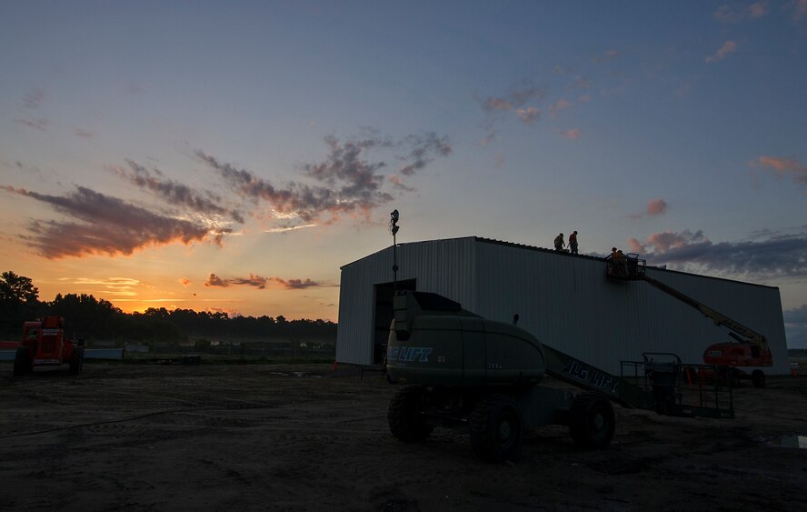 RED HORSE Reservists lay panels on the roof of a new storage building July 19 that they are building at Joint Base Charleston, S.C. Members of the 556th RHS from Hurlburt Field, Florida, 555th RHS from Nellis Air Force Base, Nevada, 567th RHS from Seymour Johnson AFB, North Carolina, and the 628th Civil Engineer Squadron at Joint Base Charleston, joined the 560th RHS over a 6 month period to construct a 4,800 square-foot steel frame storage facility. (U.S. Air Force photo by Michael Dukes)