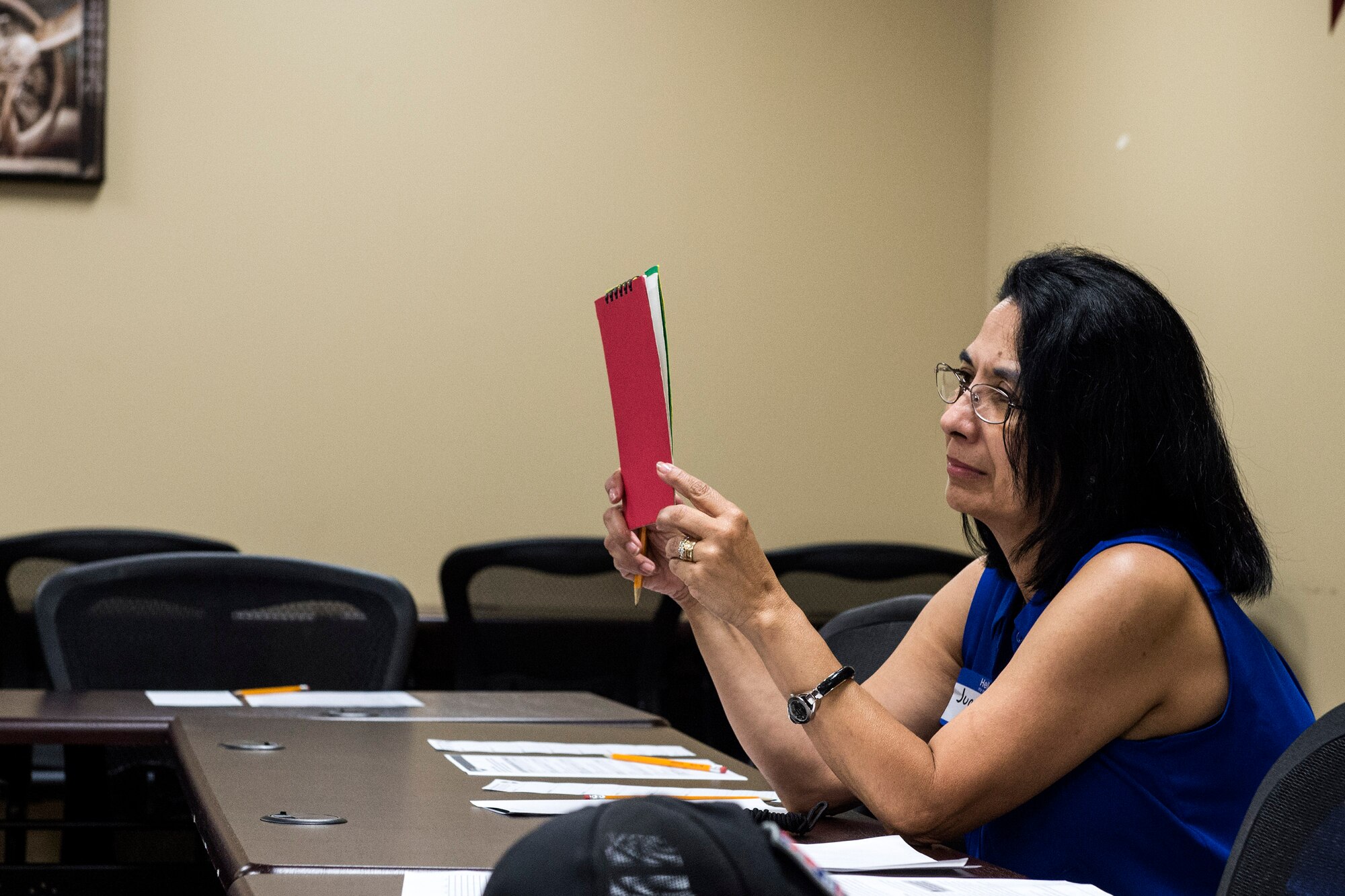 Juanita Walker, Moody Talking Tigers founding member, holds a red card up during a speech, Aug. 25, 2016, at Moody Air Force Base, Ga. During this portion of the meeting, Walker acted as the timer, who ensures speakers stay within the time limit for their speech. (U.S. Air Force photo by Airman 1st Class Janiqua P. Robinson)