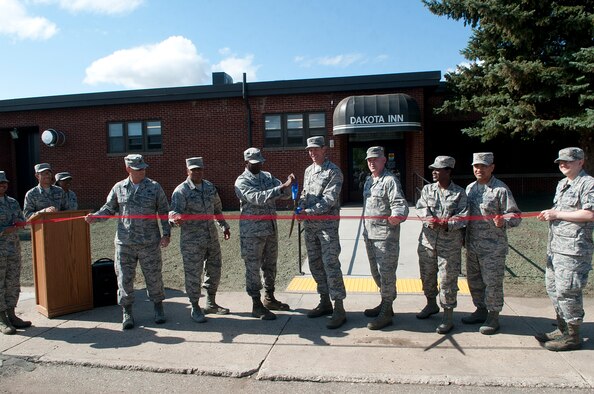 Col. Matthew Brooks, 5th Bomb Wing commander, along with base leadership, prepares to cut the ribbon at the grand opening of the Dakota Inn Dining Facility at Minot Air Force Base, N.D., Aug. 25, 2016. The newly renovated dining facility is now open to anyone with base access. (U.S. Air Force photo/Airman 1st Class Jonathan McElderry)