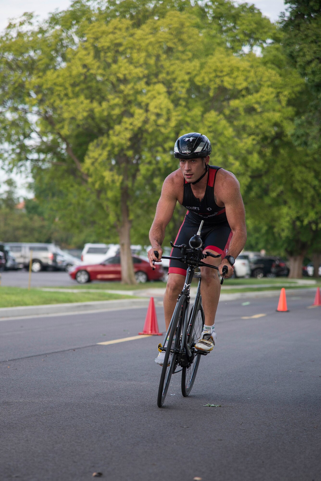 A Team Scott member competes in the bicycle portion of the Surface Warrior Challenge, at Scott Air Force Base, Ill., Aug. 27, 2016. Each portion of the triathlon featured a full and miniature competition. For the bicycle portion, participants could either complete a 10.6 kilometer or a 31.8 kilometer bike ride. (U.S. Air Force photo by Tech. Sgt. Jonathan Fowler)