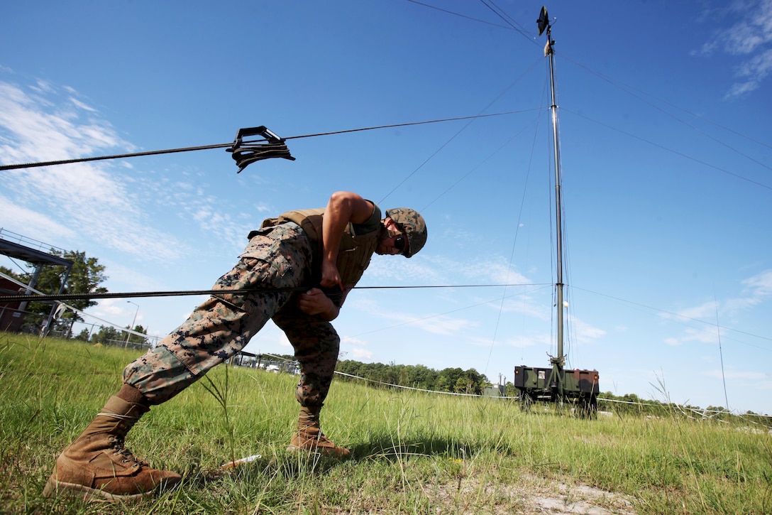 Lance Cpl. Hector Coronado tightens the stabilizing line to a Tactical Elevated Antenna Mast System during a field exercise conducted by Alpha Company, Marine Wing Communications Squadron 28, aboard Marine Corps Air Station Cherry Point, N.C., Aug. 23, 2016. The two-week exercise occurs annually to satisfy training and readiness requirements and serve as an opportunity for Marines to reaffirm previously learned skillsets. Coronado is a field radio operator with MWCS-28(U.S. Marine Corps photo by Cpl. Jason Jimenez/Released)

