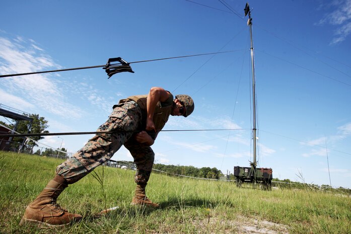 Lance Cpl. Hector Coronado tightens the stabilizing line to a Tactical Elevated Antenna Mast System during a field exercise conducted by Alpha Company, Marine Wing Communications Squadron 28, aboard Marine Corps Air Station Cherry Point, N.C., Aug. 23, 2016. The two-week exercise occurs annually to satisfy training and readiness requirements and serve as an opportunity for Marines to reaffirm previously learned skillsets. Coronado is a field radio operator with MWCS-28(U.S. Marine Corps photo by Cpl. Jason Jimenez/Released)

