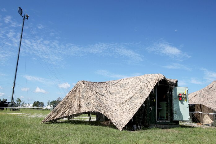 A maintenance shed is set in front of a Tactical Elevated Antenna Mast System during a field exercise conducted by Alpha Company, Marine Wing Communications Squadron 28, aboard Marine Corps Air Station Cherry Point, N.C., Aug. 23, 2016. The two-week exercise occurs annually to satisfy training and readiness requirements and serve as an opportunity for Marines to reaffirm previously learned skillsets. (U.S. Marine Corps photo by Cpl. Jason Jimenez/Released)

