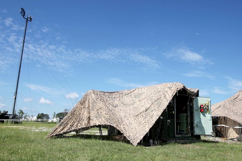 A maintenance shed is set in front of a Tactical Elevated Antenna Mast System during a field exercise conducted by Alpha Company, Marine Wing Communications Squadron 28, aboard Marine Corps Air Station Cherry Point, N.C., Aug. 23, 2016. The two-week exercise occurs annually to satisfy training and readiness requirements and serve as an opportunity for Marines to reaffirm previously learned skillsets. (U.S. Marine Corps photo by Cpl. Jason Jimenez/Released)


