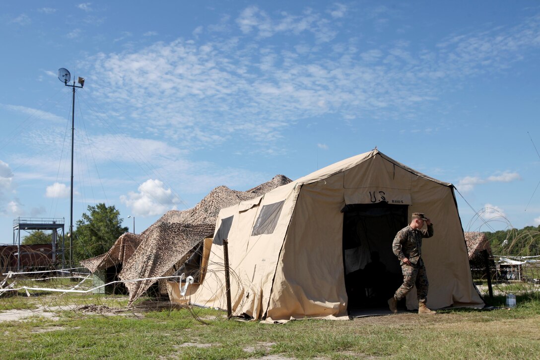 Sgt. Austin Cardwell walks out of a tent in front of a Tactical Elevated Antenna Mast System during a field exercise conducted by Alpha Company, Marine Wing Communications Squadron 28, aboard Marine Corps Air Station Cherry Point, N.C., Aug. 23, 2016. The two-week exercise occurs annually to satisfy training and readiness requirements and serve as an opportunity for Marines to reaffirm previously learned skillsets. Cardwell is a cyber-network operator with MWCS-28. (U.S. Marine Corps photo by Cpl. Jason Jimenez/Released)

