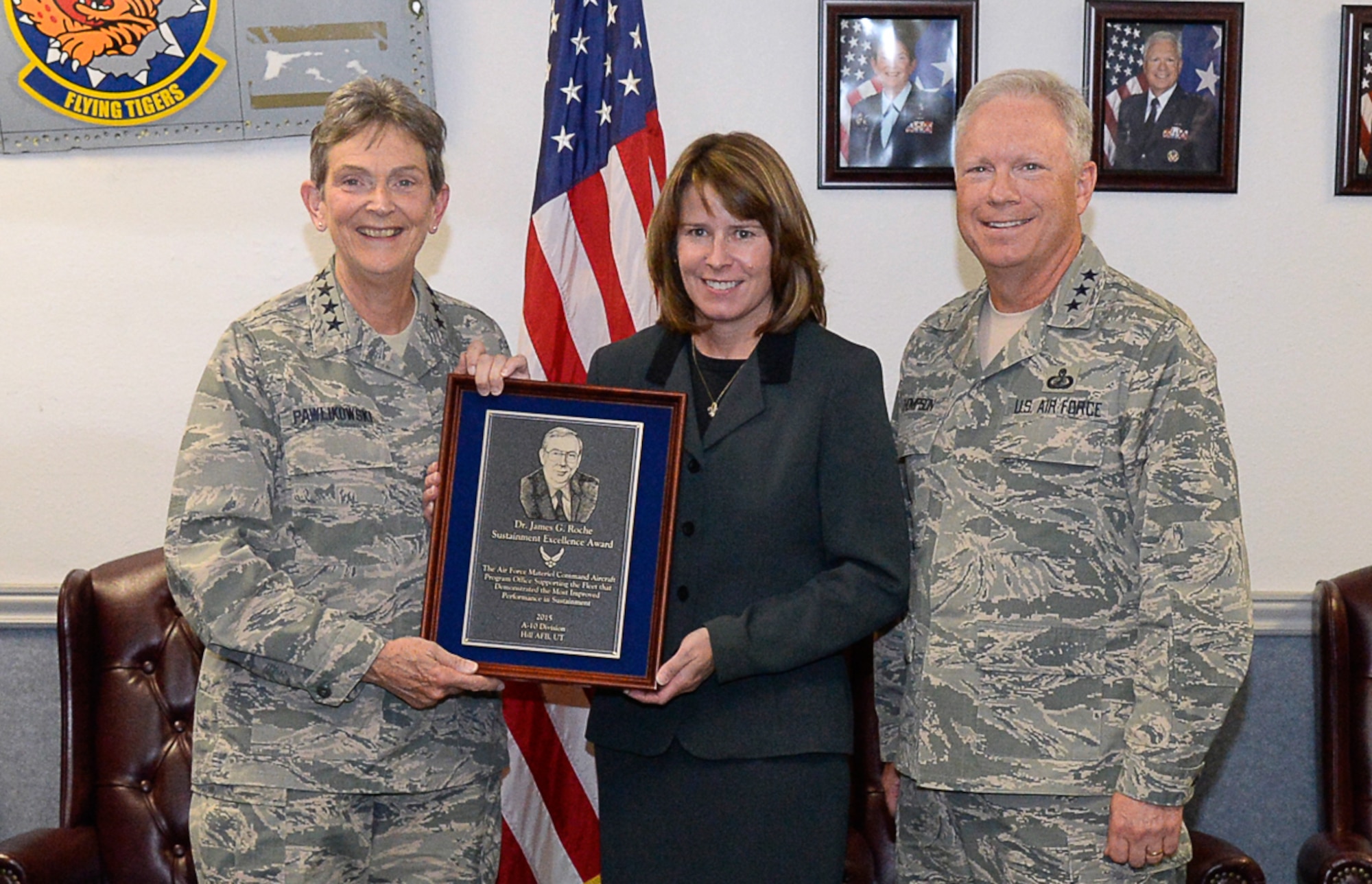 Gen. Ellen Pawlikowski, Air Force Materiel Command commander, presents the 2015 Dr. James G. Roche Sustainment Excellence Award to Dawn Sutton, A-10 System Program Office team leader, Aug. 31 during a meeting of AFMC leaders at Hill AFB.  Also pictured is Lt. Gen. John Thompson, Air Force Life Cycle Management Center commander. The award is presented annually based upon objective criteria to the AFMC program office with the most improved performance in fleet sustainment during the given fiscal year.  (U.S. Air Force photo by Todd Cromar)
