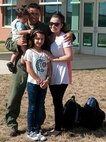 1st Lt. Ruben Labrador, 69th Bomb Squadron electronics warfare officer, poses for a photo with his family during a welcome home event at Minot Air Force Base, N.D., Aug. 25, 2016. The continuous bomber presence mission has been around for more than 10 years and was supported by the 5th Bomb Wing during that time. (U.S. Air Force photo/Airman 1st Class Jonathan McElderry)