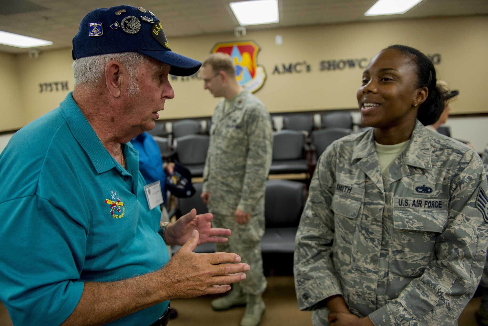 A Korean War veteran and Mosquito member talks to Scott Air Force Base Airmen about his experience in the military, Aug. 26, 2016, Scott AFB, Illinois. The Korean War Mosquitos visited Scott to learn about the present day Air Force and the installation, and the members shared their many stories about their jobs and missions as radio operators and pilots during the Korean War. (U.S. Air Force photo by Senior Airman Joshua Eikren)