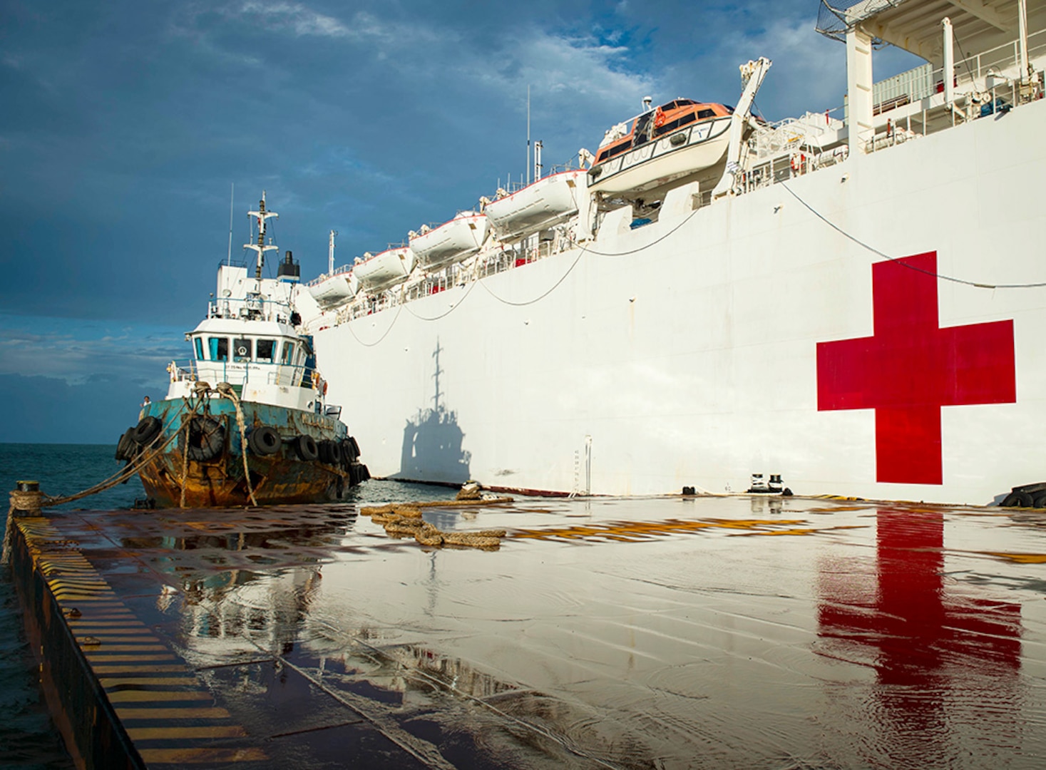 Indonesian Tug boat Milla Mulia SHS moored next to hospital ship USNS Mercy (T-AH 19), anchored off the coast of Padang, during Pacific Partnership 2016's fifth and final mission stop, Aug. 26, 2016. Partner nations are working side-by-side with local organizations during disaster response training, civil engineering projects, Women, Peace, and Security seminars, medical subject matter expert exchanges and a live field training exercise aimed at improving the capacity of local government, civilian agencies and partner militaries to collectively respond in crisis. 