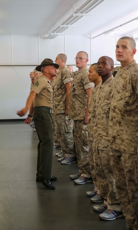Sergeant Yezid M. Beltran, drill instructor, Mike Company, 3rd Recruit Training Battalion, corrects a recruit during pick up at Marine Corps Recruit Depot San Diego, Aug. 26. In the first hours recruits are with their drill instructors they learn the rules and regulations of recruit training, covering everything from how to act in the squad bay to how to speak to the drill instructors. Annually, more than 17,000 males recruited from the Western Recruiting Region are trained at MCRD San Diego. Mike Company is scheduled to graduate Nov. 18.