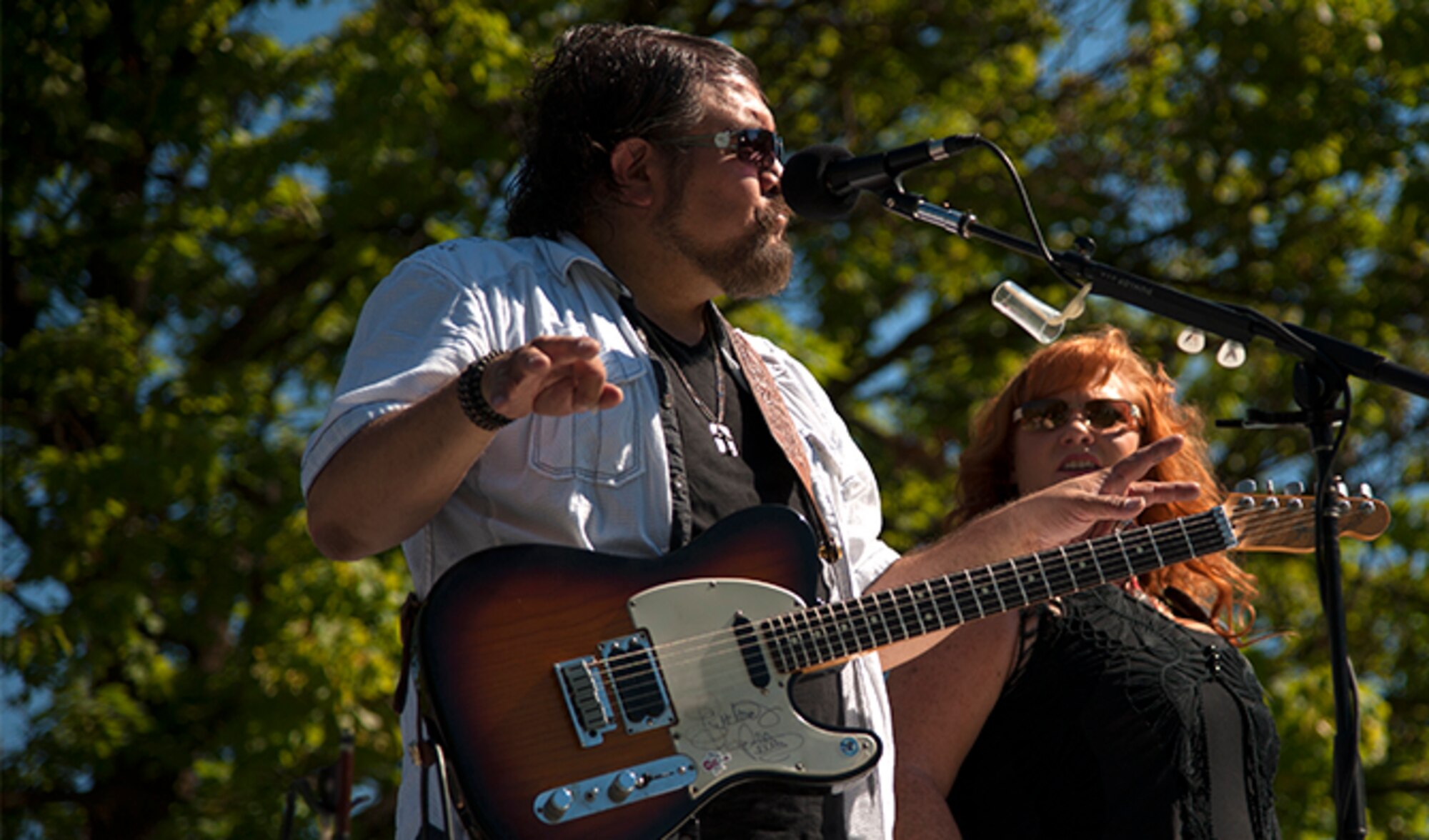 Keith Niehenke and Julie Layne Niehenke, lead guitarist and singer for The Hankers, play country music for the crowd during the Food Truck Festival, Aug. 26, 2016, at Fairchild Air Force Base, Wash. The Hankers, a country, southern rock and blues band, provided music throughout the event as well as the singing of the national anthem. 