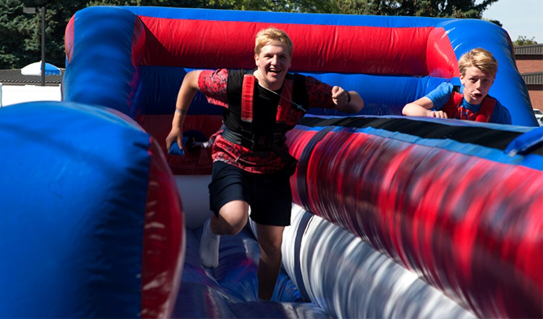 Kids enjoy the inflatable carnival games during the Food Truck Festival, Aug. 26, 2016, at Fairchild Air Force Base, Wash. The festival was host to several inflatable attractions, oversized games, and a pool for children of all ages. (U.S. Air Force photo/Airman 1st Class Ryan Lackey)