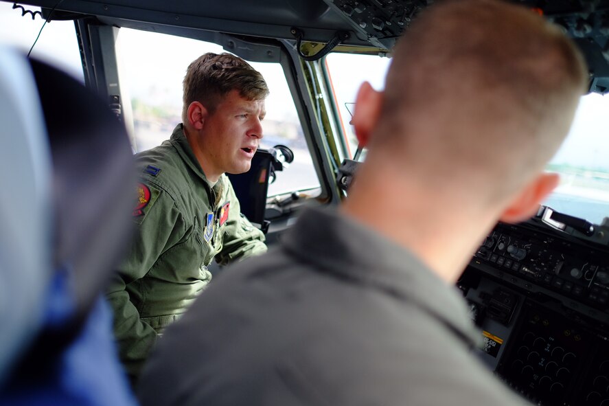 Capt. Ryan Lutz, 535th Airlift Squadron aircraft commander, reviews the pre-flight checklist with his co-pilot on Aug. 31, 2016. Lutz and the crew are slated to deliver various emergency relief supplies and generators to the Big Island, as it is slated to be hit by Hurricane Madeline. (U.S. Air Force photo by Staff Sgt. Christopher Stoltz/Released)