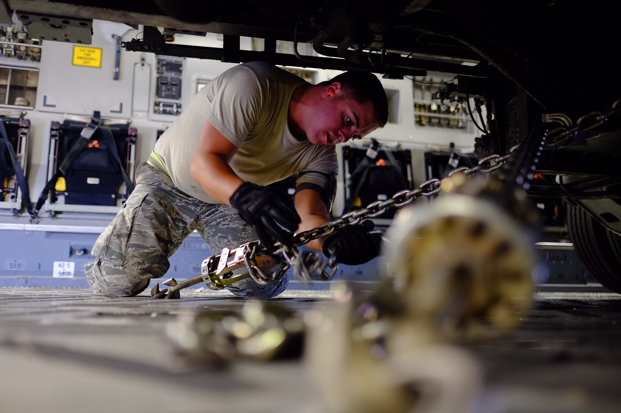 Senior Airman Robert Bonte, 55th Aerial Port Squadron load planner from Travis AFB, Calif., secures a K Loader into a C-17 Globemaster III aircraft on Aug. 31, 2016. Bonte and the crew are slated to deliver various emergency relief supplies and generators to the Big Island, as it is slated to be hit by Hurricane Madeline. (U.S. Air Force photo by Staff Sgt. Christopher Stoltz/Released)
