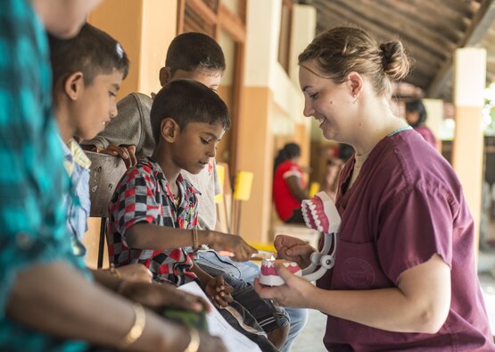 Senior Airman Makensy Lefler, a 354th Dental Squadron dental technician, teaches local children how to properly brush their teeth during Pacific Angel 16-3 in Jaffna, Sri Lanka, Aug. 20, 2016. Pacific Angel is a total force, joint and combined humanitarian assistance and civil military operation led by U.S. Pacific Air Forces. Assistance during Pacific Angel included general health, dental, optometry and physical therapy. (U.S. Air Force photo/Senior Airman Brittany A. Chase)