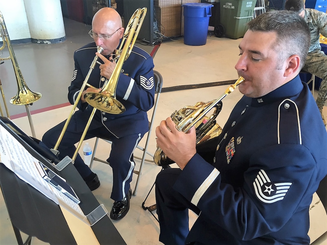 Technical Sergeant Clay Sattazahn, trombone, and Technical Sergeant Jeremy Buss, French Horn of Brass in Blue perform pre-ceremony music in support of the 175th Wing, Maryland Air National Guard.  The ceremony activated the 175th Cyberspace Operations Group which will provide cyber command readiness inspections, critical infrastructure and vulnerability assessments as well as support interagency partners. (Courtesy Photo)