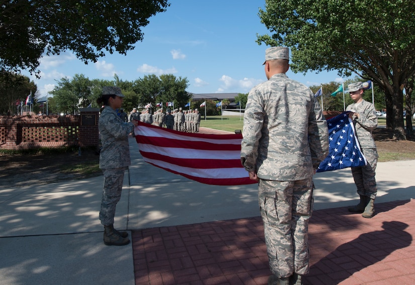 Airmen from Joint Base Charleston fold the flag during a retreat ceremony to recognize Women’s Equality Day at Joint Base Charleston, South Carolina, Aug. 26, 2016. Women’s Equality Day is observed on August 26 to highlight the progression of women’s equality in the U.S. (U.S. Air Force photo by Staff Sgt. Andrea Salazar/Released)