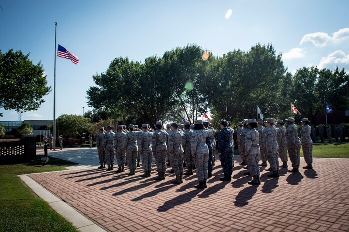Team Charleston service members salute the American flag during a retreat ceremony recognizing Women’s Equality Day at Joint Base Charleston, South Carolina, Aug. 26, 2016. Women in America earned the right to vote 96 years ago and, since then, have continued fighting for equal rights in society, the community and the workplace. (U.S. Air Force photo by Staff Sgt. Andrea Salazar/Released)