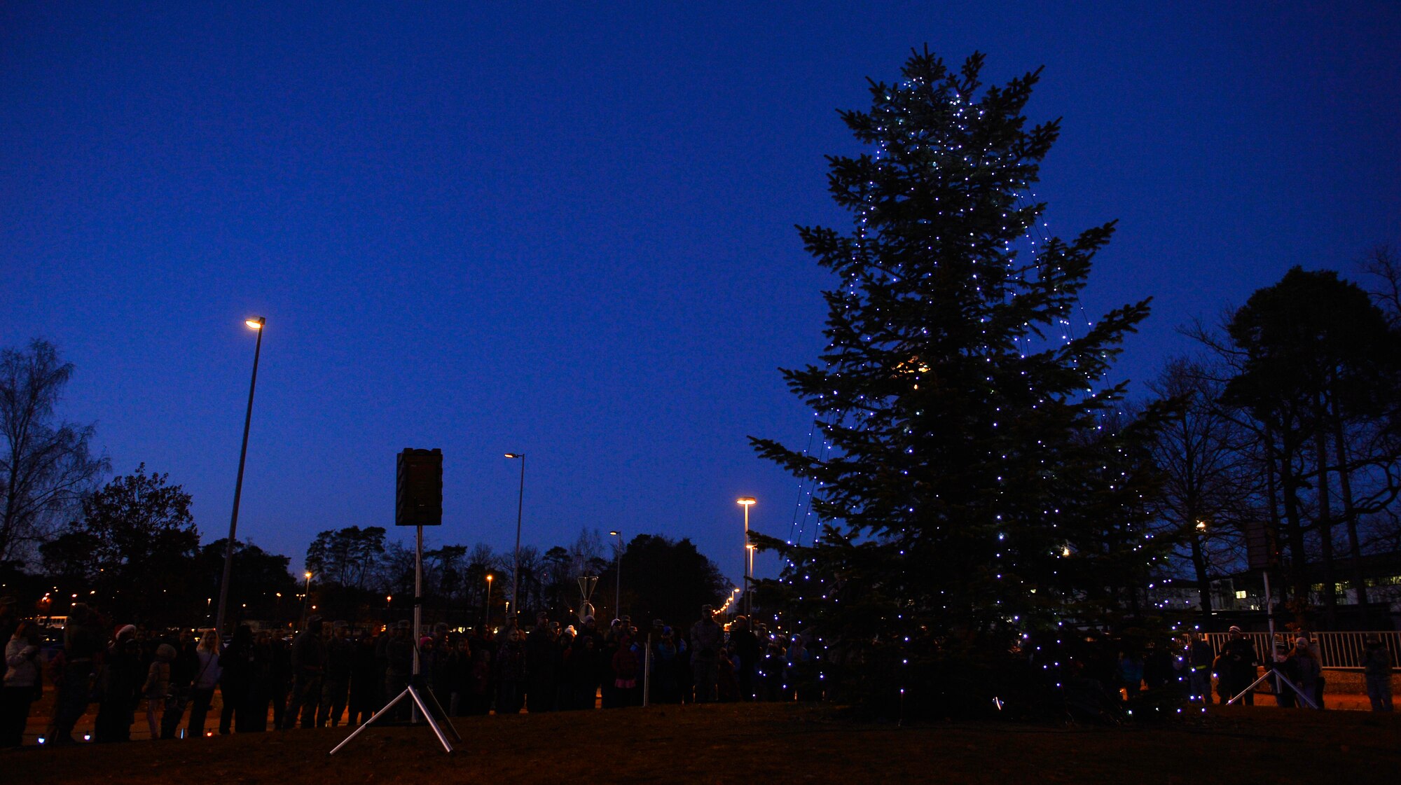 Ramstein Air Base officials and other members of the Kaiserslautern Military Community attend the annual tree lighting ceremony of the base’s official Christmas tree, here, Nov. 28, 2016. The town of Ramstein-Miesenbach, Germany, donated the tree in 2010, and was planted on a traffic circle on base in 2011. (U.S. Air Force photo by Airman 1st Class Joshua Magbanua)