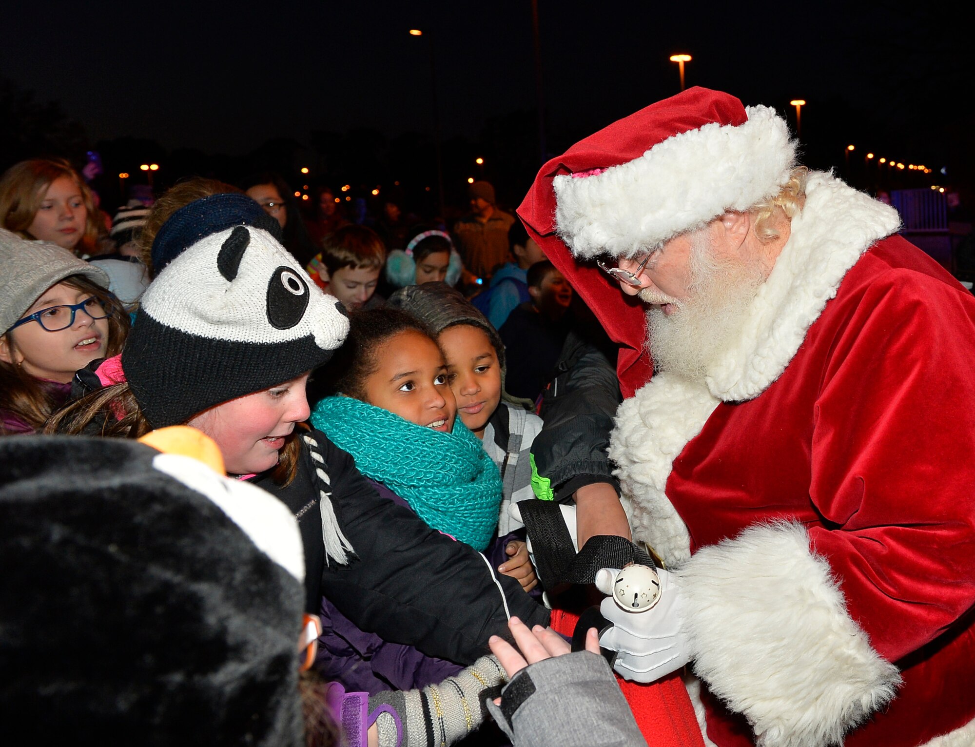 Santa Claus hands out candy to children after a Christmas tree lighting ceremony at Ramstein Air Base, Germany, Nov. 28, 2016. For the ceremony, Santa arrived in a red firetruck instead of the traditional reindeer sleigh. (U.S. Air Force photo by Airman 1st Class Joshua Magbanua)