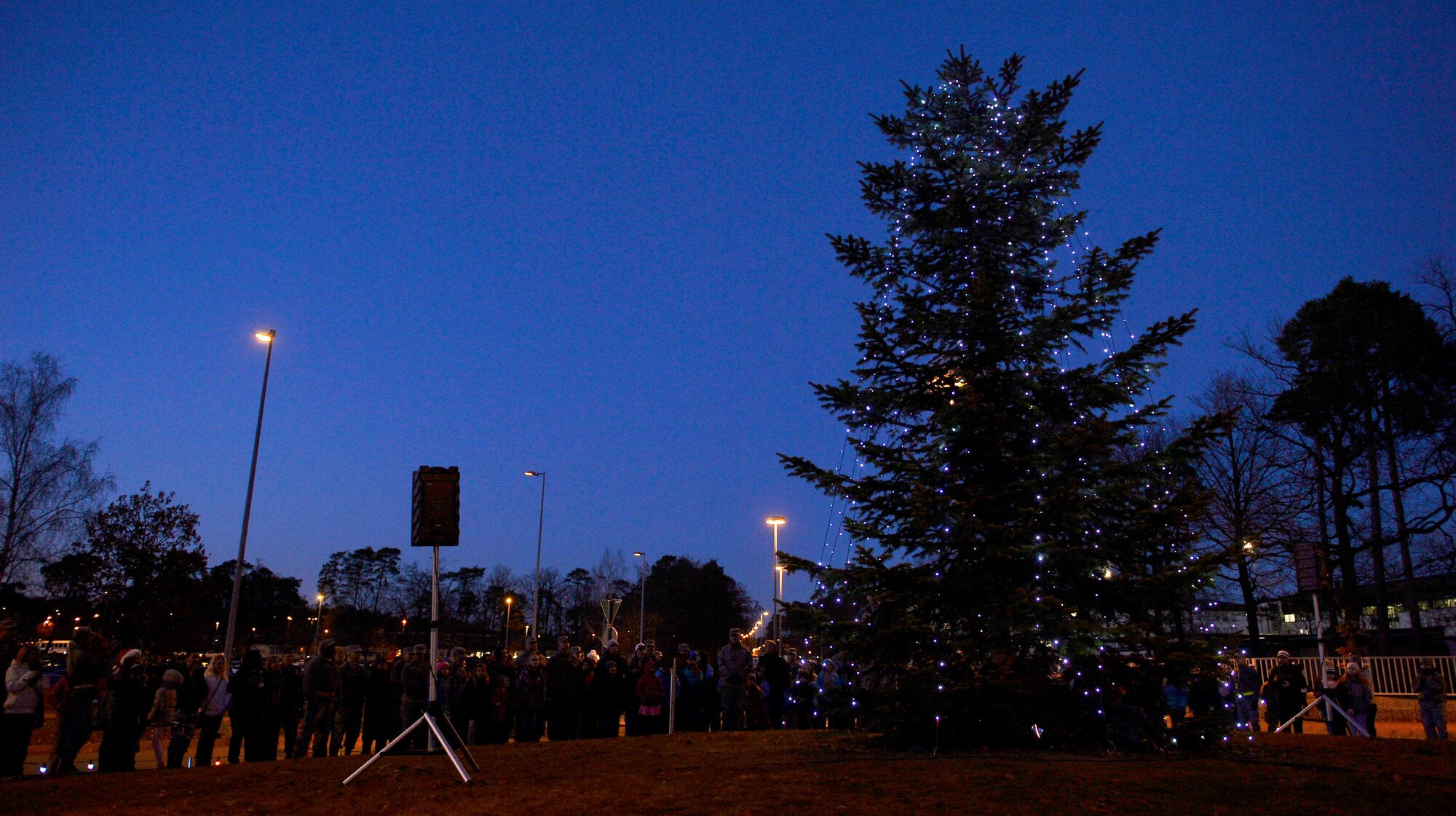 Ramstein Air Base officials and other members of the Kaiserslautern Military Community attend the annual tree lighting ceremony of the base’s official Christmas tree, here, Nov. 28, 2016. The town of Ramstein-Miesenbach, Germany, donated the tree in 2010, and was planted on a traffic circle on base in 2011. (U.S. Air Force photo by Airman 1st Class Joshua Magbanua)